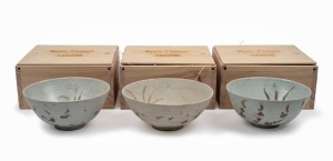 BINH THUAN SHIPWRECK group of three Chinese porcelain bowls, late Ming, circa 1600, housed in bespoke timber boxes with Christies labels and branding, 9cm high, 20cm diameter each.