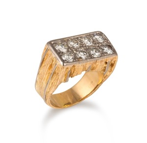 An imposing 18ct gold gents ring, set with eight large brilliant cut white diamonds, mid to late 20th century, stamped "18ct", 28.4 grams total.