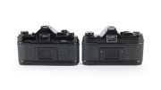 CANON: Pair of 1970s black-body SLRs, comprising Canon A-1 (Zoom FD 35-70mm f3.5-4.5) and Canon AE-1 (FD SSC 50mm f1.4). - 2