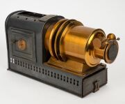 NEGRETTI & ZAMBRA: Circa 1900s magic lantern, black-lacquered tin body, dual side-opening doors with blue glass peepholes; dimensions 22 x 13.5 x 40cm. - 2