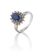 A 14ct white gold ring, set with an Australian blue sapphire surrounded by white diamonds, 20th century, 4.3 grams.