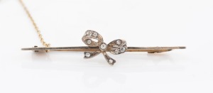 A vintage 9ct gold and diamond bow brooch, early 20th century, 5.5cm wide, 3.2 grams.