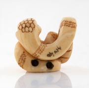 A Japanese carved ivory serpent netsuke, signed on the reverse, 19th/20th century, ​​​​​​​2.5cm high, 3cm wide. - 2