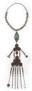 A tribal silver chatelaine necklace adorned with turquoise and coins, 19th/20th century, 62cm long overall.
