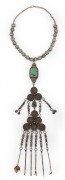A tribal silver chatelaine necklace adorned with turquoise and coins, 19th/20th century, 62cm long overall.