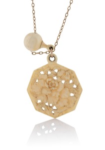 An antique carved ivory pendant on 9ct gold chain, early 20th century, the ivory pendant6.5cm high, the chain 40cm long.