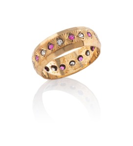 A vintage 9ct gold eternity ring, adorned with a row of alternating rubies and white diamonds, 20th century, 2.7 grams total.