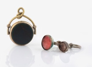 Three antique silver fobs, two with hardstone seals, the swivel example with carnelian and bloodstone, 19th century, the largest 3.5cm high.