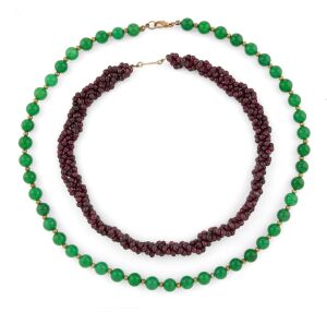A polished garnet bead necklace with gold clasp; together with a jade coloured bead necklace with gilt metal clasp, (2 items), 48cm and 36cm long.