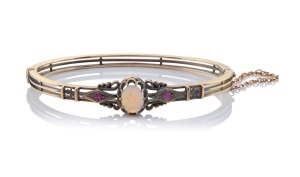 HARRY PAGE (1835&ndash;1915) of Geelong, antique 15ct gold bangle, set with a solid cabochon opal flanked by two rubies, 19th century, stamped "H. Page", internal measurement 6cm wide, 14.2 grams total.