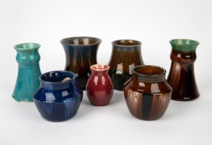 Seven assorted Australian pottery vases in blue, cream, pink and brown glazes, the largest 15cm high.