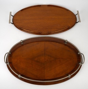 Two vintage Australian oval serving trays, Queensland silky oak and blackwood, early to mid 20th century, the larger 56cm across the handles.