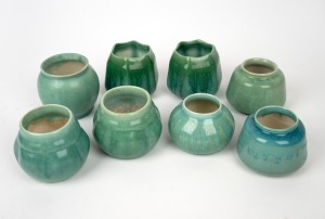 MELROSE WARE group of nine green glazed pottery vases, the largest 8cm high.