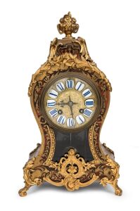 An antique French boule cased spring table clock with ormolu mounts, Roman numeral enamel cartouche dial with eight day time and gong striking movement, 19th/20th century, 34cm high.