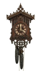 An antique German Black Forest cuckoo wall clock by THEODORE KETTERER, with carved and fretted Gothic influence oak case, carved and fretted bone hands and Roman numerals with wood plate movement, circa 1870, the case 47cm high, 27cm wide.