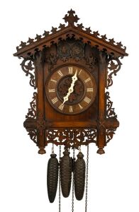 An antique German Black Forest cuckoo and quail wall clock, attributed to JOHANN BAPTIST BEHA, 30-hour duration wood plate movement, carved walnut station house style case with decorative pierced scroll leaf and vine decoration, bone hands and applied Roman numerals, circa 1860, the case 49cm high, 39cm wide.