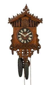 An antique German Black Forest cuckoo wall clock in carved and fretted oak gothic style case, fretted bone hands, 30 hour wood plate movement striking the hour and half hour on a coil gong, circa 1875, 45cm high, 26cm wide.
