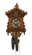 An antique German Black Forest cuckoo wall clock in carved and fretted oak gothic style case, fretted bone hands, 30 hour wood plate movement striking the hour and half hour on a coil gong, circa 1875, 45cm high, 26cm wide.