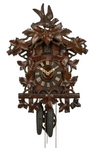 An antique German Black Forest cuckoo wall clock in carved case with vine leaf decoration and cuckoo finial. Fancy fretted and carved bone hands, plus Roman numerals. 30 hour brass plate movement striking the hour and half hour on a coil gong, circa 1890, 50cm high, 37cm wide.