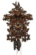 An antique German Black Forest cuckoo wall clock in carved case with vine leaf decoration and cuckoo finial. Fancy fretted and carved bone hands, plus Roman numerals. 30 hour brass plate movement striking the hour and half hour on a coil gong, circa 1890,