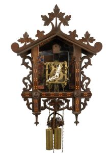 An antique German Black Forest railway cuckoo wall clock in carved and fretted linden wood case with Tunbridge style parquetry banding, later fitted transparent dial plate displaying the fretted brass plate 30 hour movement, cuckoo and bellows, circa 1900, 50cm high, 36cm wide.