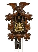 An antique German Black Forest cuckoo wall clock in carved linden adorned with vine leaf decoration and spread eagle finial, later fitted transparent dial plate displaying the fretted brass plate 30 hour movement, cuckoo and bellows. Fancy carved bone han
