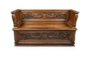 An antique Florentine carved walnut casapanca, 18th century, 101cm High, 172cm wide, 54cm deep.