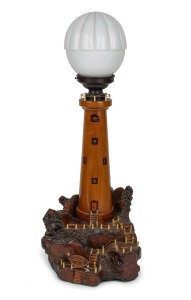 A vintage lighthouse table lamp with mulga wood base, bakelite fittings and milk glass shade, circa 1920s, ​​​​​​​62cm high.
