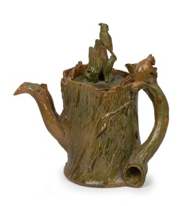 WILLIAM RICKETTS rare green glazed pottery teapot of tree stump form adorned with applied koala and parrot finial, incised "W. RICKETTS, 1934", 18cm high.