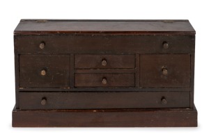 An antique Australian folk art stained pine miniature cabinet with lit-top and five drawers, 19th/20th century, 24cm high, 46cm wide, 11cm deep.