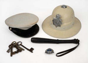 Vintage police pith helmet, police cap, truncheon and assorted keys, (qty).