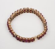 A stunning 18ct gold bracelet adorned with two rows of cabochon rubies interspersed with bands of white diamonds, early to mid 20th century, ​​​​​​​18cm long, 27.2 grams total. - 3