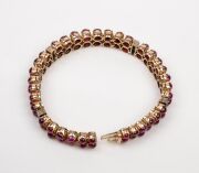 A stunning 18ct gold bracelet adorned with two rows of cabochon rubies interspersed with bands of white diamonds, early to mid 20th century, ​​​​​​​18cm long, 27.2 grams total. - 4