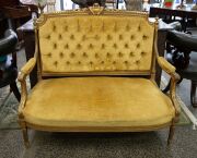 An antique French Louis XVI style gilded settee with handsome carved decoration and gold velvet upholstery, 19th century, 100cm high, 120cm across the arms.