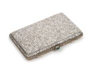 A fine quality antique Continental silver case with engraved floral decoration and cabochon emerald clasp, circa 1900, 7.5cm wide, 55 grams total.