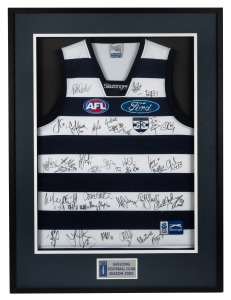 GEELONG SEASON 2005: Display incorporating a Cats guernsey with no fewer than thirty-eight signatures, including those of Gary Ablett Jr., Joel Corey, Henry Playfair, Tim Callan, and more; framed and glazed, 102 x 76cm overall.