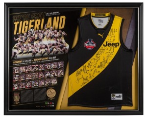 RICHMOND 2017 PREMIERSHIP: "We're From Tigerland" guernsey and replica medal display, signed by all 22 Premiership players as well as coach Damien Hardwick; limited edition #218/1000 with CoA; attractively framed and glazed, 87 x 107cm overall.