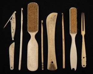 Antique whale bone brushes, crochet needles, folding pocket spoon and implements, mostly 19th century, (9 items), ​​​​​​​the largest 15cm long.