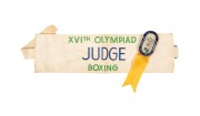 OFFICIAL BADGE - SPORTS & TEAM OFFICIALS: Manufactured by K.G. Luke, Melbourne; dark blue enamelled border, silver background, yellow ribbon marked "BOXING"; numbered "2296" on reverse, together with armband marked "XVIth OLYMPIAD - JUDGE - BOXING". (2 it - 2