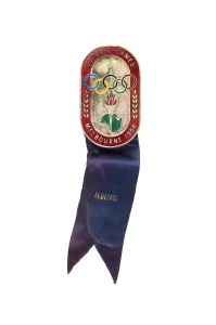 OFFICIAL BADGE - COMPETITORS: Manufactured by K.G. Luke, Melbourne; red enamelled border, silver background, dark blue ribbon by Raleigh Print marked "FOOTBALL"; numbered "6378" on reverse.