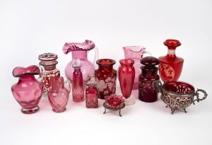 Thirteen pieces of assorted ruby and cranberry glass, comprising of jugs, pickle jars, bottles etc., 19th and 20th century, the largest 21cm high.