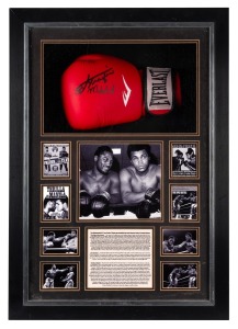 MUHAMMAD ALI v JOE FRAZIER: An "Everlasting" boxing glove signed by both Ali and Frazier, in display case with photographs and texts recounting the pair's boxing rivalry; CoA present; dimensions 70 x 49 x 15cm.
