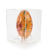 An artwork titled "Football Spirits" by Australian indigenous artist Kathleen Kemarre Wallace (1948 - 2024), comprising a football decorated with an intricate design in yellow, black, white, and gold; housed in bespoke perspex case measuring approx. 30 x - 2