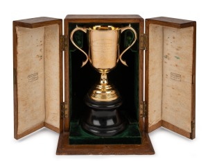 PRINCE OF WALES GOLD CUP: 15ct gold trophy by Hardy Bros, on wooden plinth, offered with original oak case, engraved "Australian Jockey Club/Winter Meeting/In Honour of H.R.H. The Prince of Wales/19th June 1920/Prince of Wales Gold Cup/1 Mile and five furlongs/Dead Heat Between T. Hickey's ch.g. 'Silverton' 5yrs. 6st. 11lbs. by St. Alwyne (imp)-Prudential And H.W. Morton's Blk.g. 'Parkdale' 6yrs. 8st. 2lbs. by Royal Artillery-Fancy Free/Time 2m. 46¾ sec."