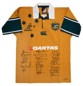 WALLABIES: Circa 2004 official commemorative short-sleeved rugby jumper, player edition [#PL249] issued to Eddie Jones, with twenty-three original signatures including those of George Gregan, George Smith, Eddie Jones, Stephen Larkham, Stirling Mortlock, and Matt Giteau; size M.