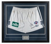 THE 2009 GRAND FINAL - GEELONG 12.8.80 defeated ST.KILDA 9.14.68 A match-worn pair of shorts, signed and endorsed by STEVE JOHNSON. Attractively framed & glazed. Overall 65 x 76cm.