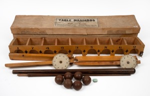 "Table Billiards - The Popular Australian Game" in maker's box; set comprises two scoreboards, target housing with nine entrances (length 78cm), twist-together cue, and seven wooden balls; early 20th century.