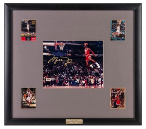 MICHAEL JORDAN: A signed display incorporating four different Upper Deck or Topps trading cards and a central photograph of Jordan performing a "slam dunk"; framed and glazed, 50 x 57cm overall.