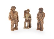 Three different ceramic clay figurines of cricketers holding bats; the tallest 23cm.