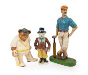 A pair of statuettes of cricketers leaning on their bats, one a ceramic English cricketer with matte glaze, the other a ceramic resin anthropomorphic bear wearing baggy green, plus one other; late 20th century, the tallest 40cm. (3 items)